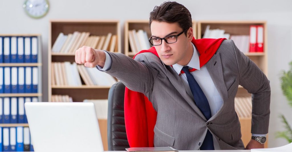 Image of a superhero office worker wearing a cape, thrusting his fist out to indicate that he has a win – perhaps he negotiated a volume discount after tracking his purchase orders in Dynamics 365 Business Central!